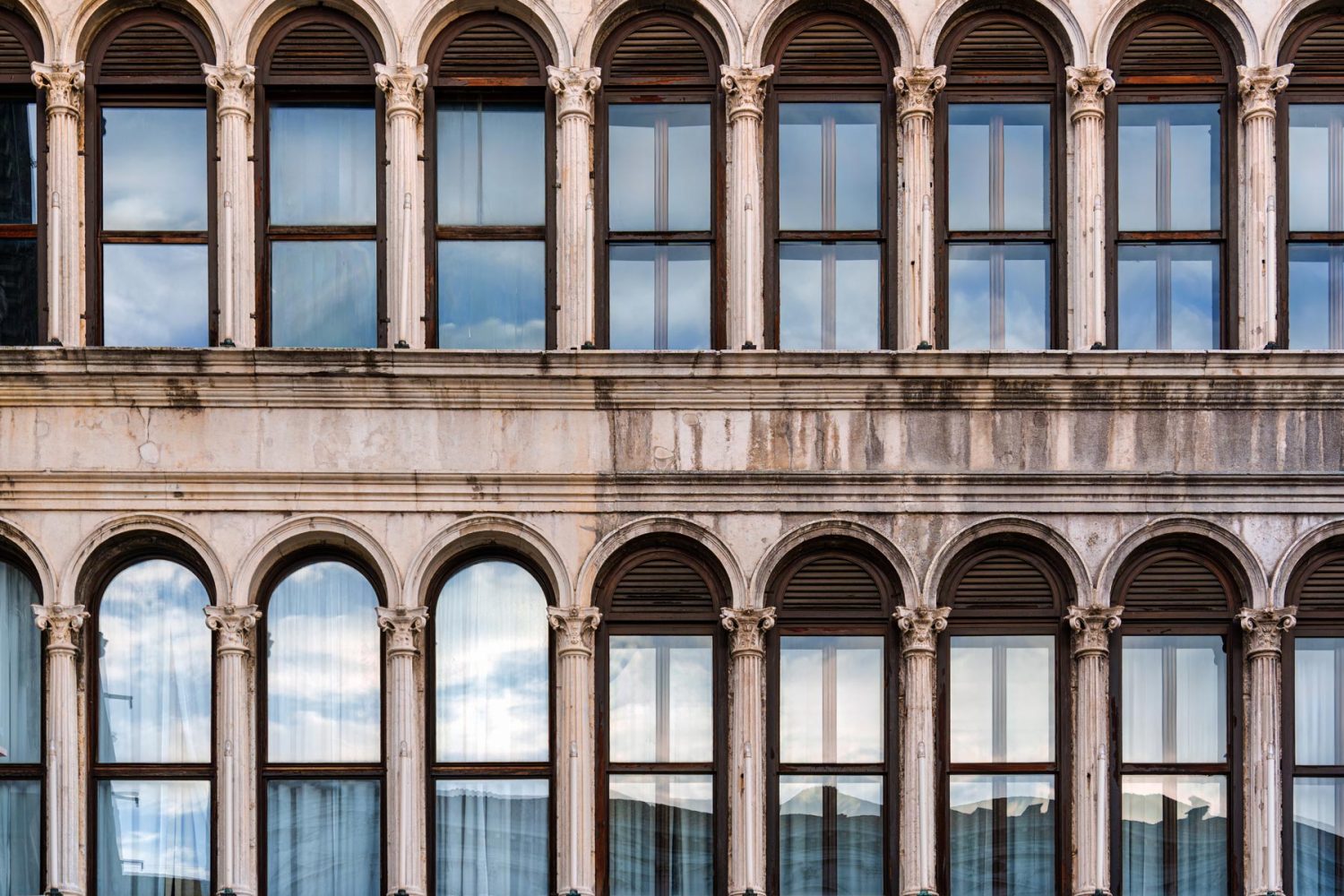 historic-classic-building-facade-with-arched-windo-2026-01-12-17-40-24-utc